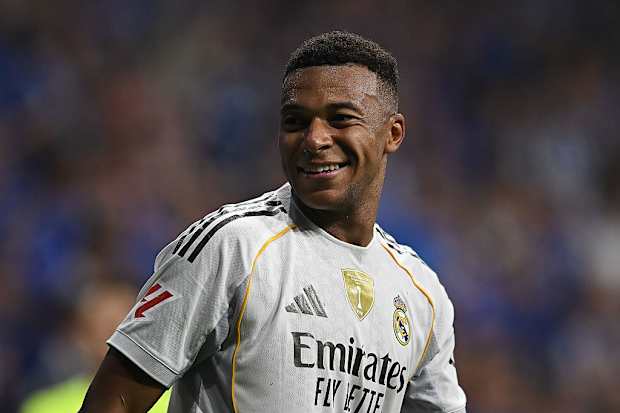 Kylian Mbappé looking unwell during a press conference.
