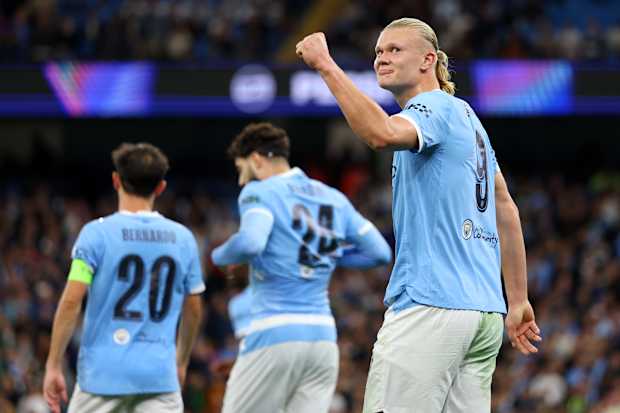 Erling Haaland celebrates reaching 100 career goals, surpassing Premier League legends.