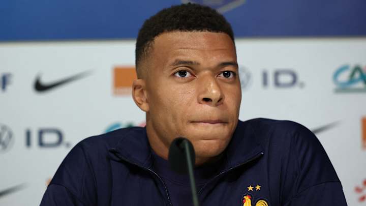Kylian Mbappé looking pensive during a match.